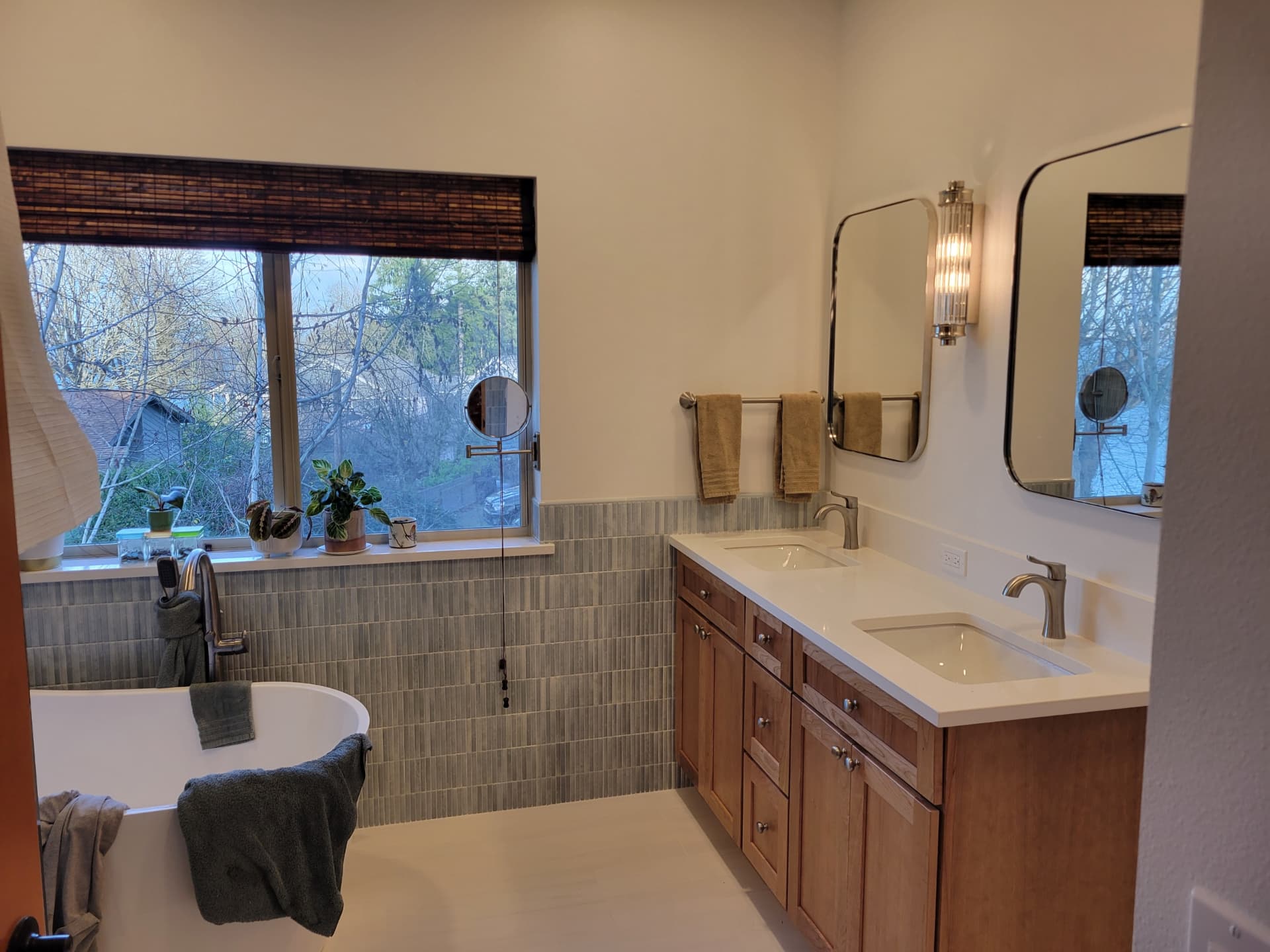 Primary bathroom remodel with freestanding tub, blue-green tile wainscot and oak double vanity