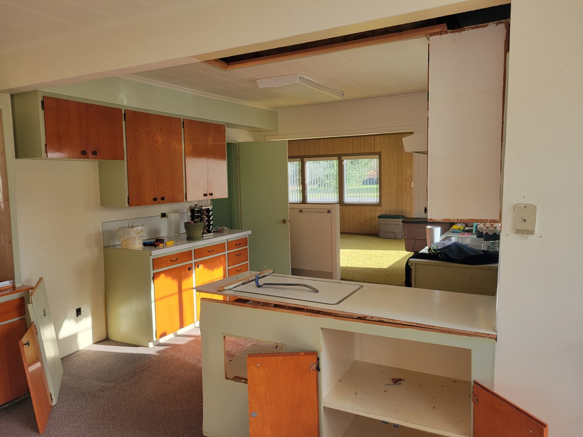 Mid-century kitchen during demolition with cabinets and soffits removed